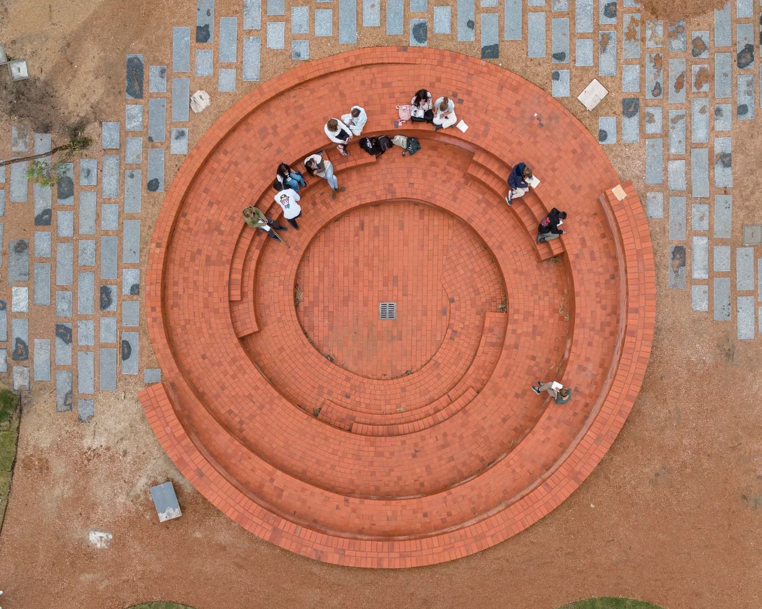 Secondary School - Aerial view of students in a circular outdoor learning space