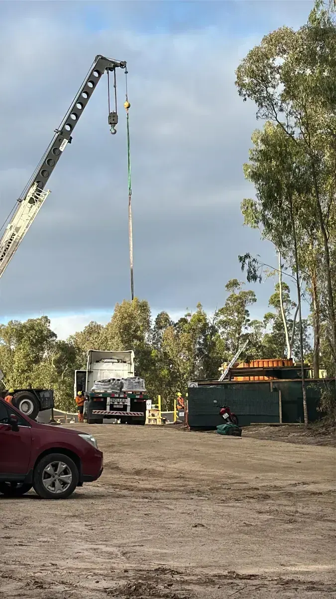 Crane unloading materials on site