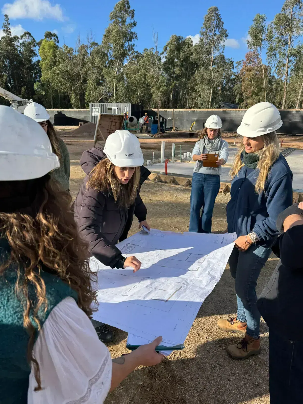 Team reviewing blueprints on site