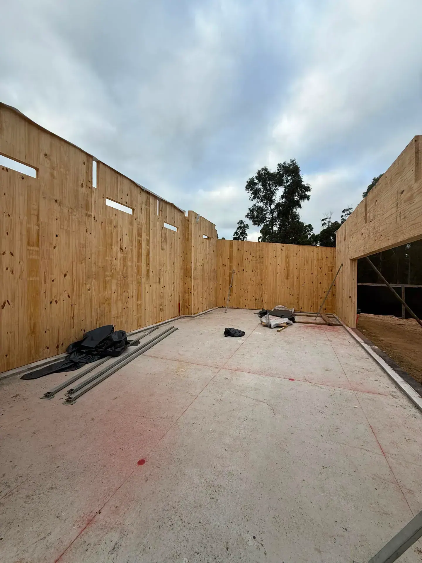 Wide interior perspective of enclosed CLT walls on the slab